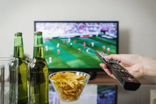 watching football with remote food and drinks