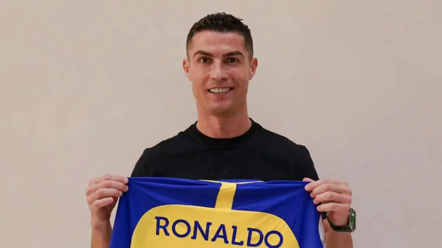 Christiano Ronaldo holding up an Al Nassr jersey